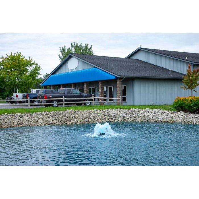 Scott_Aerator_Boilermaker_Surface_Aerator_in_pond_with_trucks_and_building_in_background