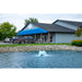 Scott_Aerator_Boilermaker_Surface_Aerator_in_pond_with_trucks_and_building_in_background