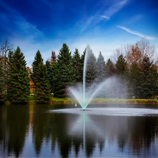 scott_aerator_skyward_pond_fountain_with_green_led_light_kit_in_water_with_trees_in_background